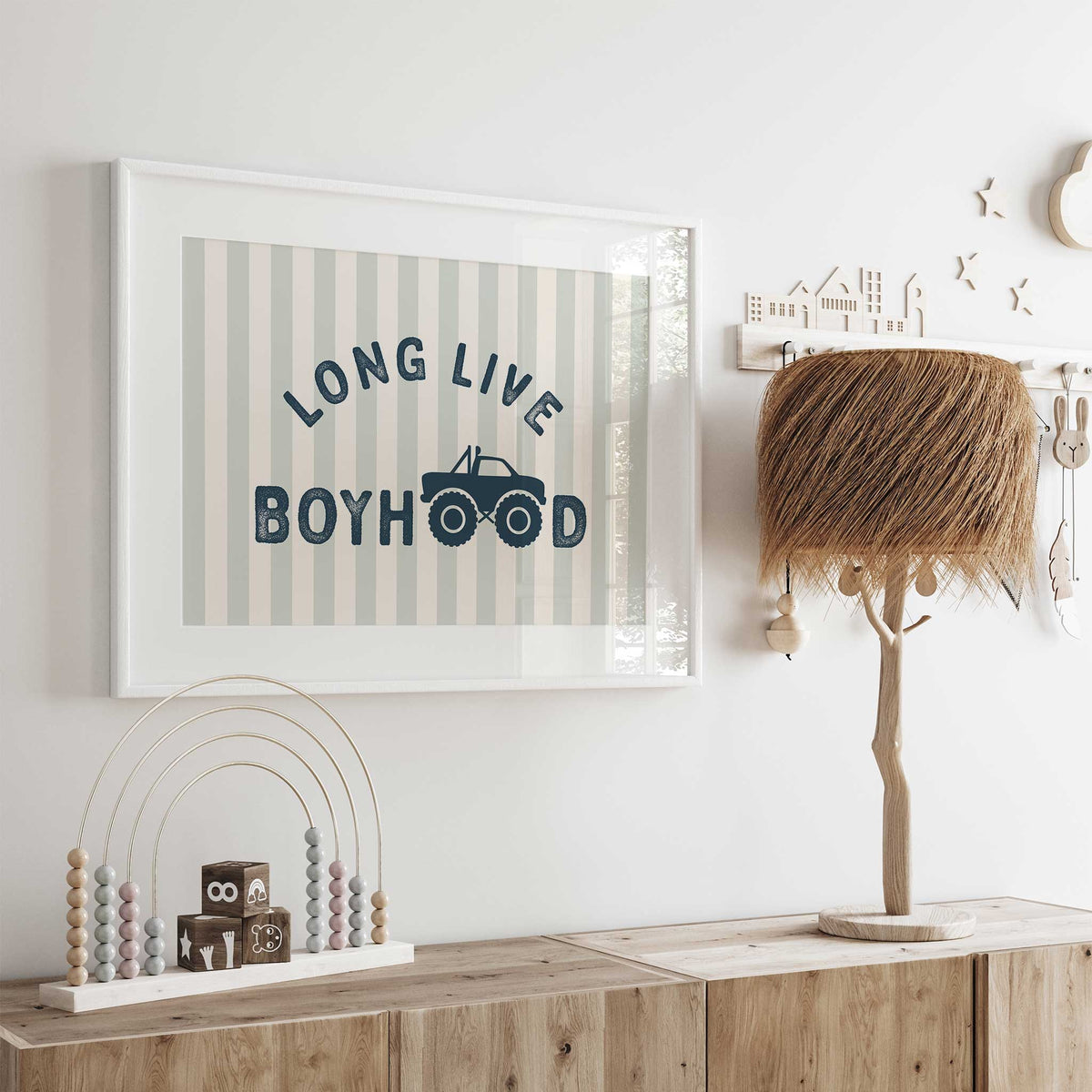 Striped Long Live Boyhood artwork with navy letters and a monster truck forming the O letters in Boyhood on sage and cream.