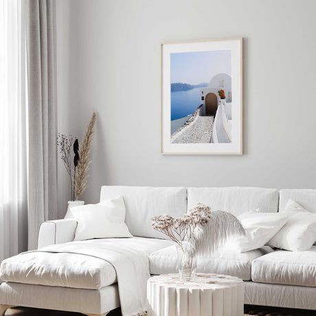 Santorini Aegean Sea print with whitewashed walls, red flowers and ocean views.