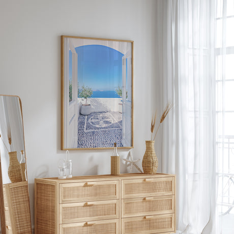 Santorini coastal wall art print featuring traditional white Greek architecture, olive trees and a calm blue sea view