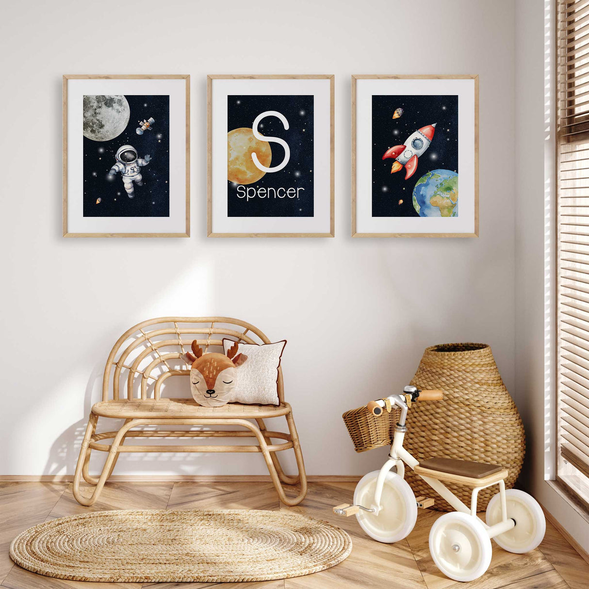 Set of three navy space prints featuring an astronaut, rocket and personalised initial name artwork for a child’s room