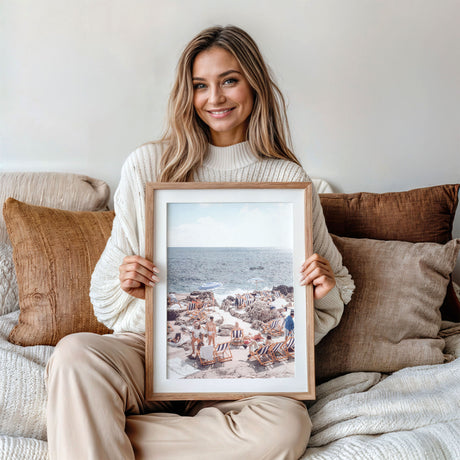 Relaxed beach holiday scene with people lounging on rocky Mediterranean shore