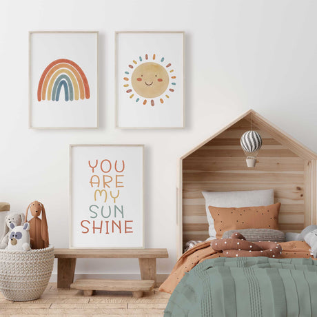 Trio of nursery prints with smiling sun, colourful rainbow, and “You Are My Sunshine” text in minimalist style