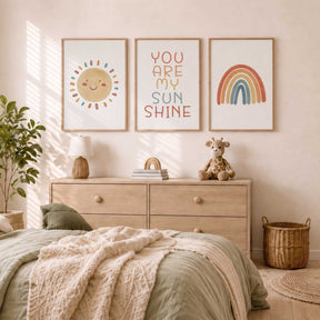 Kids wall art set of three with a smiling sunshine, multicoloured quote and rainbow on neutral background