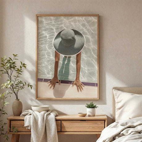 Swimming pool wall art featuring an overhead view of a woman in an oversized sunhat with her hands on the pool edge.