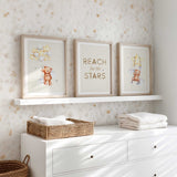Teddy bear wall art set of three featuring star illustrations and the reach for the stars quote in soft neutral tones