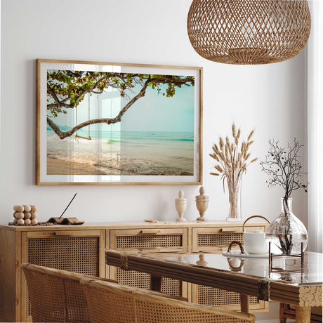 Tropical beach wall art print featuring a tree swing over the ocean with soft waves and a calm coastal view