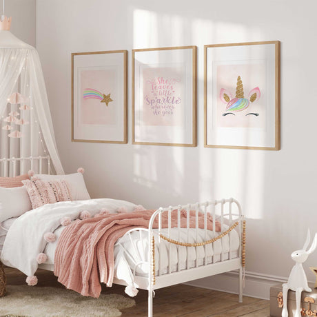 Pink unicorn wall art set of three with a rainbow shooting star, sparkle quote and pastel mane with gold-effect details.