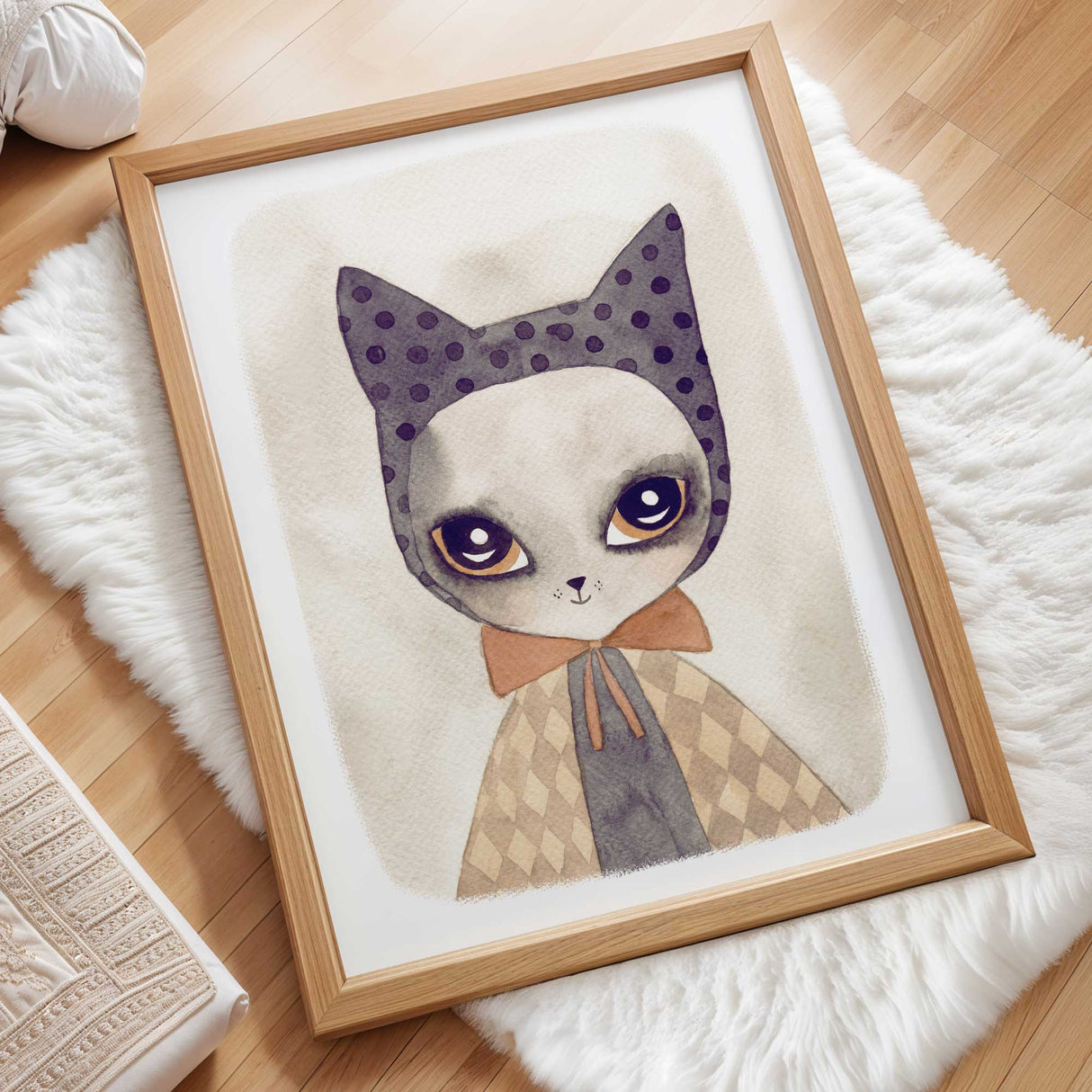 Whimsical cat wall art with large, expressive eyes and a polka dotted headpiece.