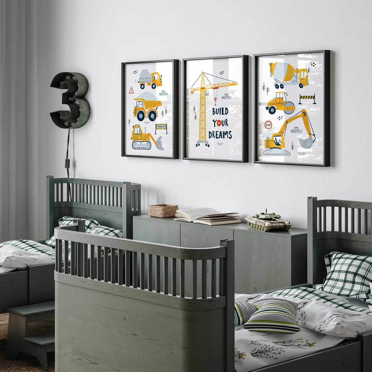 Yellow construction wall art set of three with stacked vehicles, navy lettering and a tower crane reading Build Your Dreams.