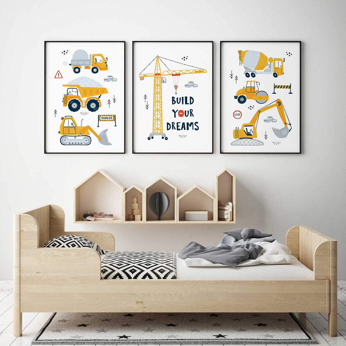 Three yellow construction prints with dump trucks, cement mixer, road roller, diggers and a Build Your Dreams crane.
