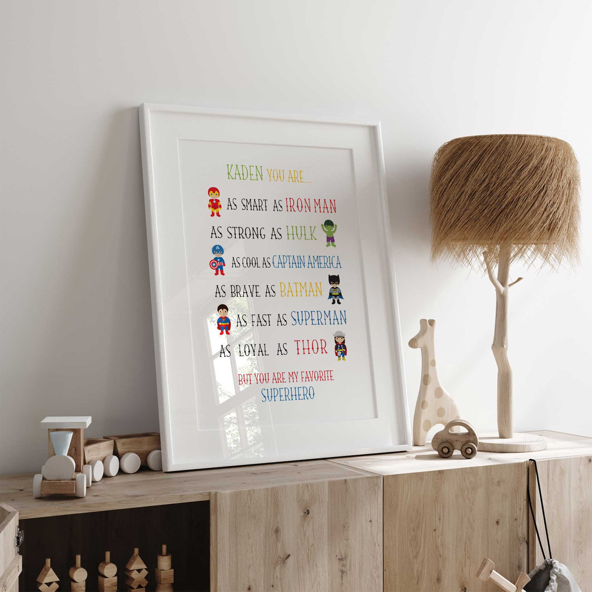Superhero-themed print on a shelf with toys in a room.