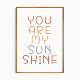Set of 3 nursery wall art prints featuring sun, rainbow, and "You Are My Sunshine" quote in soft earthy tones