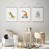 set of three watercolour nursery animal prints featuring crocodile on scooter elephant on bike and giraffe on scooter for kids rooms