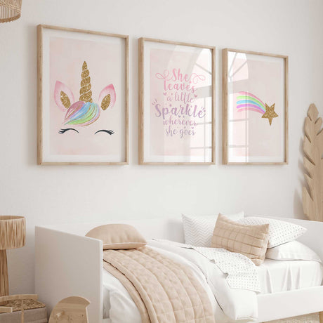 Three pink wall art prints featuring a pastel unicorn face, sparkle quote and rainbow shooting star with gold effects.